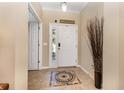 Bright foyer featuring tile flooring with decorative mosaic, white door with sidelight and modern door lock at 2731 Cypress Tree Trl, St Cloud, FL 34772