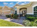 Stunning front entrance featuring a brick walkway, stone accents, and well-maintained landscaping at 2731 Cypress Tree Trl, St Cloud, FL 34772