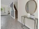 Elegant entryway with console table, mirror and staircase, creating a welcoming ambiance at 2775 Bookmark Dr, Kissimmee, FL 34746