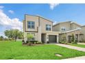 Charming home with lush green lawn and walkway leading to the front entrance and garage at 2775 Bookmark Dr, Kissimmee, FL 34746