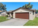 Charming single-story home featuring a brick facade, attached two-car garage, and a well-kept lawn at 2955 Foxcroft Ln, South Daytona, FL 32119