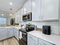 Bright kitchen featuring gray cabinets, stainless steel appliances, subway tile backsplash, and stylish decor at 3055 Aqua Virgo Loop # 47, Orlando, FL 32837