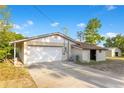 Attached two-car garage with a wide driveway, showcasing the home's practical features at 4550 Chandler Rd, Apopka, FL 32712