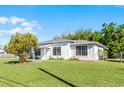 Beautifully maintained single Gathering home with a lush green lawn and a white exterior at 4751 Deer Run Rd, St Cloud, FL 34772
