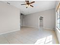 Bright living room features ceramic tile floors, fresh paint, and a ceiling fan at 4751 Deer Run Rd, St Cloud, FL 34772