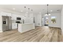 Well-lit kitchen with stainless steel appliances, a kitchen island, and hardwood flooring at 4774 Sw 142Nd Place Rd, Ocala, FL 34473
