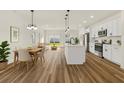 Open-concept living space with modern kitchen, dining area, and seamless access to the backyard at 4774 Sw 142Nd Place Rd, Ocala, FL 34473