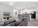 Open-concept living room featuring a comfortable seating area and seamless flow into the kitchen at 5117 Killarney Way, Kissimmee, FL 34746