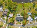 Large lot featuring lush greenery, a pool, and waterfront access at 546 Queens Mirror Cir, Casselberry, FL 32707