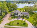 Expansive property with a well-maintained lawn and access to a serene lake at 546 Queens Mirror Cir, Casselberry, FL 32707