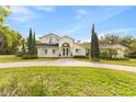 Beautiful two-story home with arched entryway and manicured lawn at 546 Queens Mirror Cir, Casselberry, FL 32707