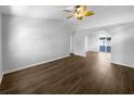 A modern empty room with hard wood floors, white walls, vaulted ceilings, and a view to the dining room at 6 Almond Trce, Ocala, FL 34472