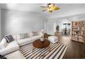 Bright living room with vaulted ceilings, wood floors, and a modern striped rug at 6 Almond Trce, Ocala, FL 34472