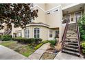 Exterior view with staircase, garden bed with lush plantings, and covered entrance at 696 Seabrook Ct # 101, Altamonte Springs, FL 32714