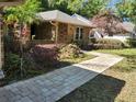Beautiful landscaped front yard with a stone paver walkway leading to the front door at 736 Silverwood Dr, Lake Mary, FL 32746