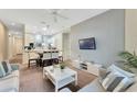 Open-concept living room with a view of the dining area and kitchen, perfect for entertaining at 806 Lucaya Loop, Davenport, FL 33897