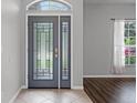 Welcoming foyer with decorative glass front door and tile flooring at 9899 Leland Dr, Orlando, FL 32827