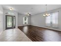 Bright living room featuring hardwood floors, large windows and elegant lighting at 9899 Leland Dr, Orlando, FL 32827