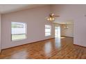 Bright living room with laminate floors, high ceilings, and natural light from multiple windows at 10020 Creekwater Blvd, Orlando, FL 32825