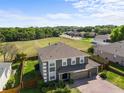 Beautiful home showcasing a spacious backyard with lush greenery and mature trees at 110 Wekiva Pointe Cir, Apopka, FL 32712