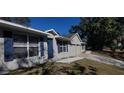 Charming single-story home with blue door, blue shutters, and a well-manicured lawn at 111 Sunnyside Dr, Clermont, FL 34711