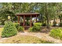 Wooden gazebo nestled among lush greenery offering a peaceful retreat in a tranquil setting at 1148 Monroe Ave, St Cloud, FL 34769