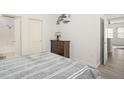 Inviting bedroom with wood floors, ensuite bathroom, and soothing wall art at 12016 Villanova Dr # 101, Orlando, FL 32837