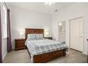 Bright, spacious bedroom with wood floors, ensuite bathroom, and neutral tones at 12016 Villanova Dr # 101, Orlando, FL 32837