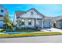 Charming single-Gathering home featuring a two-car garage, manicured lawn, and welcoming front porch at 13301 Mcmillan Dr, Orlando, FL 32827