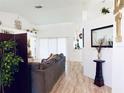 Bright living room with neutral walls, wood-look flooring, and slider doors at 13405 Sw 86Th Ave, Ocala, FL 34473