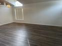 Light-filled living room featuring luxury vinyl flooring and a modern chandelier at 15746 Autumn Glen Ave, Clermont, FL 34714