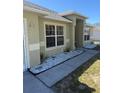 Exterior shot of a single-Gathering home featuring tidy landscaping along the walkway, a large window, and a well-kept lawn at 1956 Myakka Ct, Poinciana, FL 34759