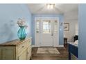 Welcoming foyer with hardwood floors and a blue accent wall at 2510 Kiowa Trl, Fern Park, FL 32730