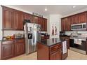 The kitchen offers dark wood cabinets, stainless steel appliances, and granite countertops at 2629 Maggiore Cir, Kissimmee, FL 34746