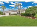Well-manicured lawn and landscaping add to the curb appeal of this single-story home with a three-car garage at 2877 Ashton Ter, Oviedo, FL 32765