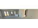 Spacious living room features ample natural light and smooth flooring, awaiting personalized touches at 30162 Rustic Mill St, Mount Dora, FL 32757