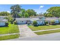 Well-kept home with a long driveway, healthy green lawn and mature landscaping at 3420 Arnel Dr, Winter Park, FL 32792