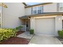 Charming townhome featuring a one car garage, covered entry and manicured landscaping at 435 Tradition Ln, Winter Springs, FL 32708