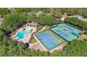 Aerial view of community amenities including pool, basketball court, and tennis courts at 4536 Barrister Dr, Clermont, FL 34711