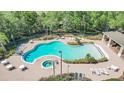 A high-angle view shows a uniquely shaped community pool, separate hot tub and ample lounge seating at 4536 Barrister Dr, Clermont, FL 34711