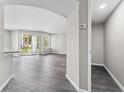 Bright, open-concept living room showcasing wood floors and natural light from the sliding glass doors at 7230 Westpointe Blvd # 1222, Orlando, FL 32835