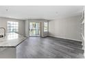 Open living space featuring wood flooring, natural light, and granite countertops at 7230 Westpointe Blvd # 1222, Orlando, FL 32835