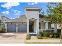 Beautiful single-Gathering home featuring a brick driveway, landscaped yard, and a gray two-car garage at 778 Gainer Way, Winter Springs, FL 32708