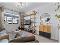 Bright living room with a large window and stylish shelving at 808 Grandin St, Davenport, FL 33837