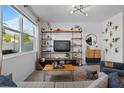 Bright living room with a large window and stylish shelving at 808 Grandin St, Davenport, FL 33837
