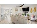 Bright and airy living room featuring stylish decor, tile flooring, and ample seating at 825 Keats Ave, Orlando, FL 32809