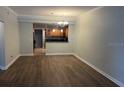 Open-concept living room featuring wood floors and a view into the kitchen at 831 N Fern Creek Ave # 101, Orlando, FL 32803
