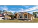 The exterior of the home showcasing a well-maintained lawn and neutral paint at 935 Gloucester Court, Kissimmee, FL 34758