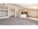 Open concept living and kitchen area with high ceilings and a breakfast bar at 935 Gloucester Court, Kissimmee, FL 34758