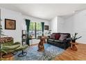 Cozy living room with large window, stylish furniture, hardwood floors, and bright, natural light at 10400 Hunters Trail Ct, Orlando, FL 32817